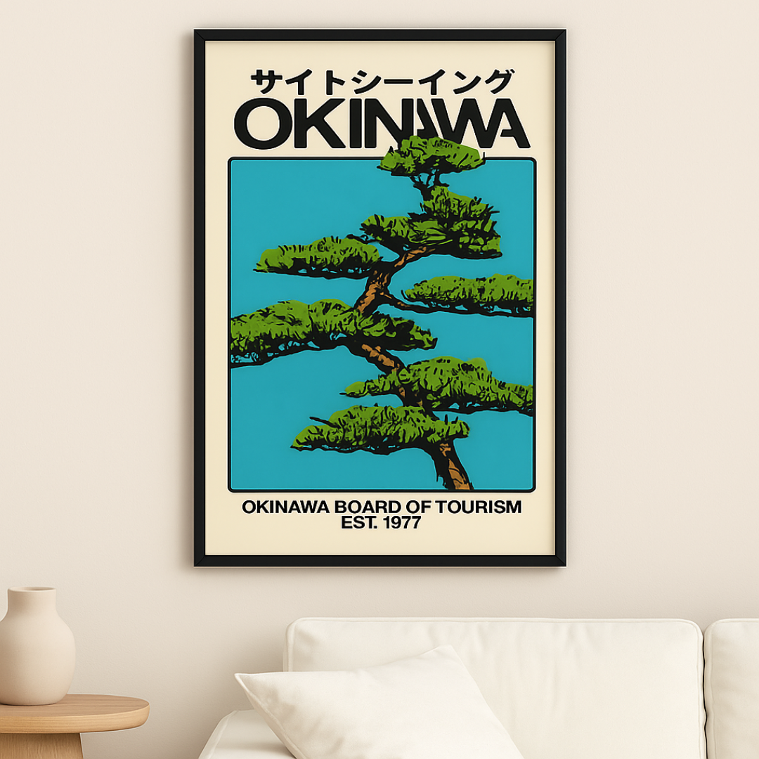 Framed poster of a tree with 'Okinawa' text on a beige wall above a white sofa.