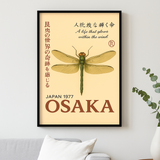 Framed poster with a dragonfly design and text on a beige background, displayed on a wall.