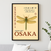 Framed poster with a dragonfly design and text on a beige background, displayed on a wall.