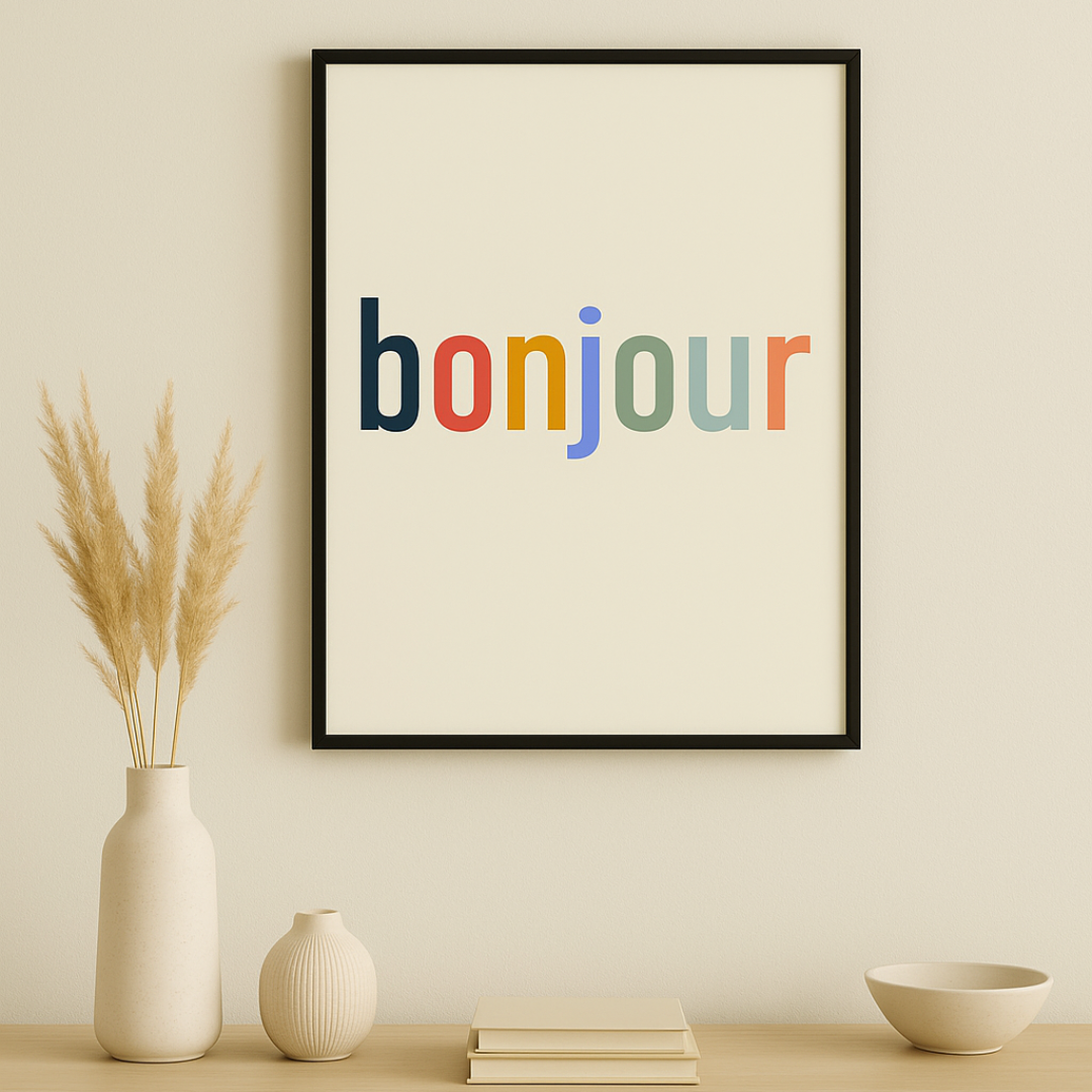 Framed poster with 'bonjour' in multicolor on a wall above a wooden cabinet.